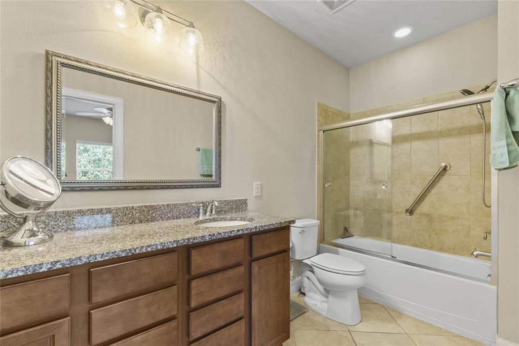 bath with single sink vanity area, a combination of tub and shower