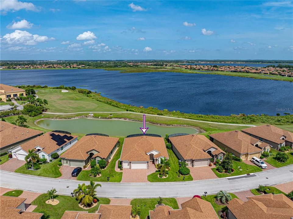 Aerial view of home with lake behind it