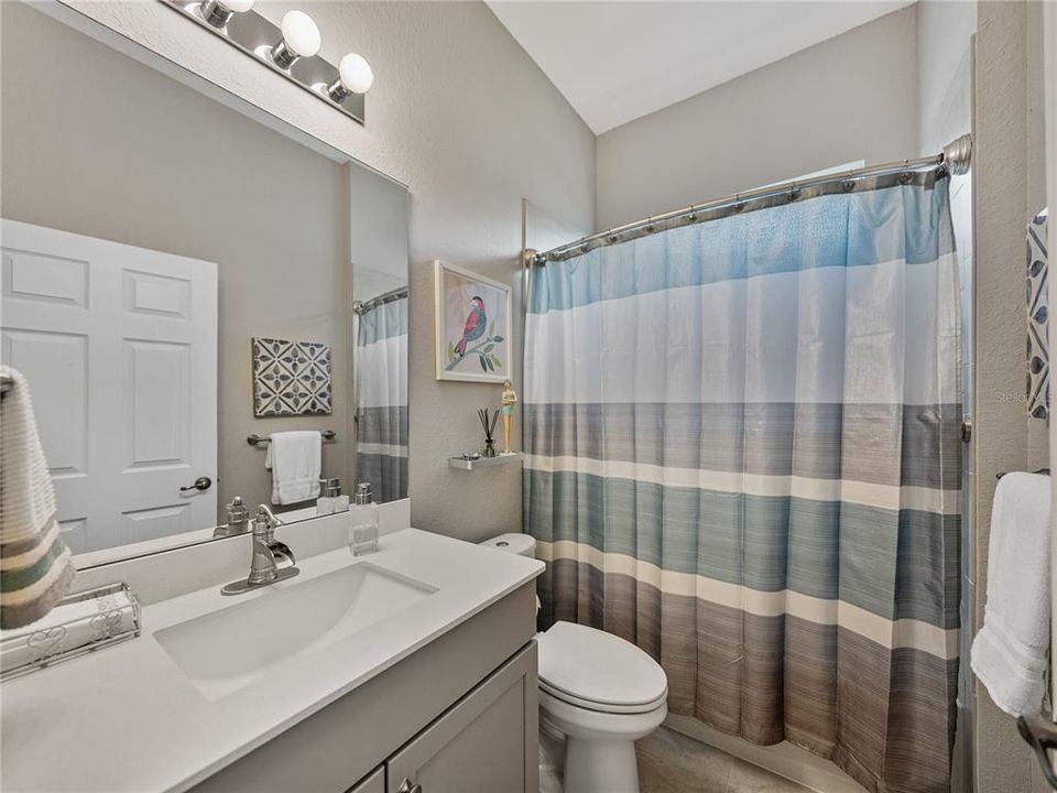 Guest Bathroom with tile surround tub/shower