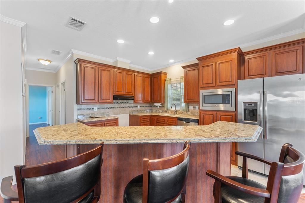 Beautifully appointed kitchen with granite countertops and ample cabinet space