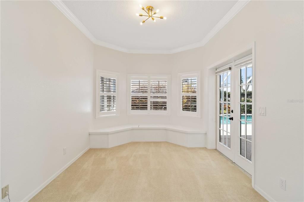 Primary bedroom, seating area with bay window and french doors to lanai