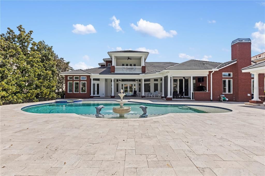 Entire pool deck area is travertine stone pavers