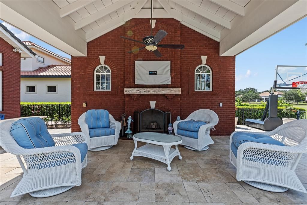 Private stand alone Cabana has fireplace, TV and storage room  behind the brick wall