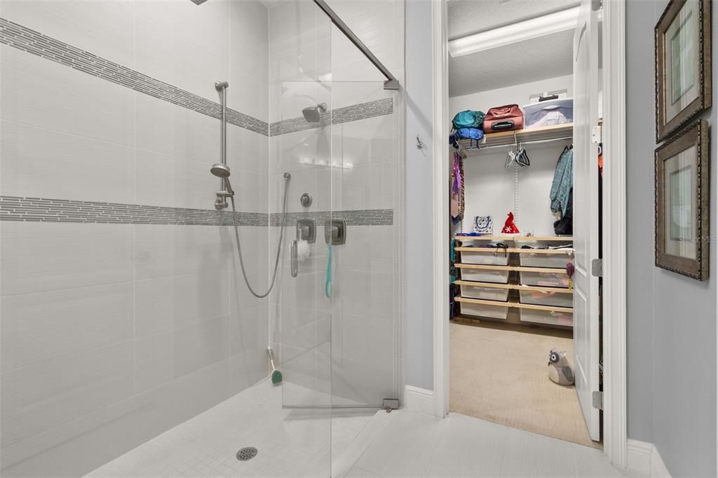 Large walk-in rain shower and closet in the primary bathroom