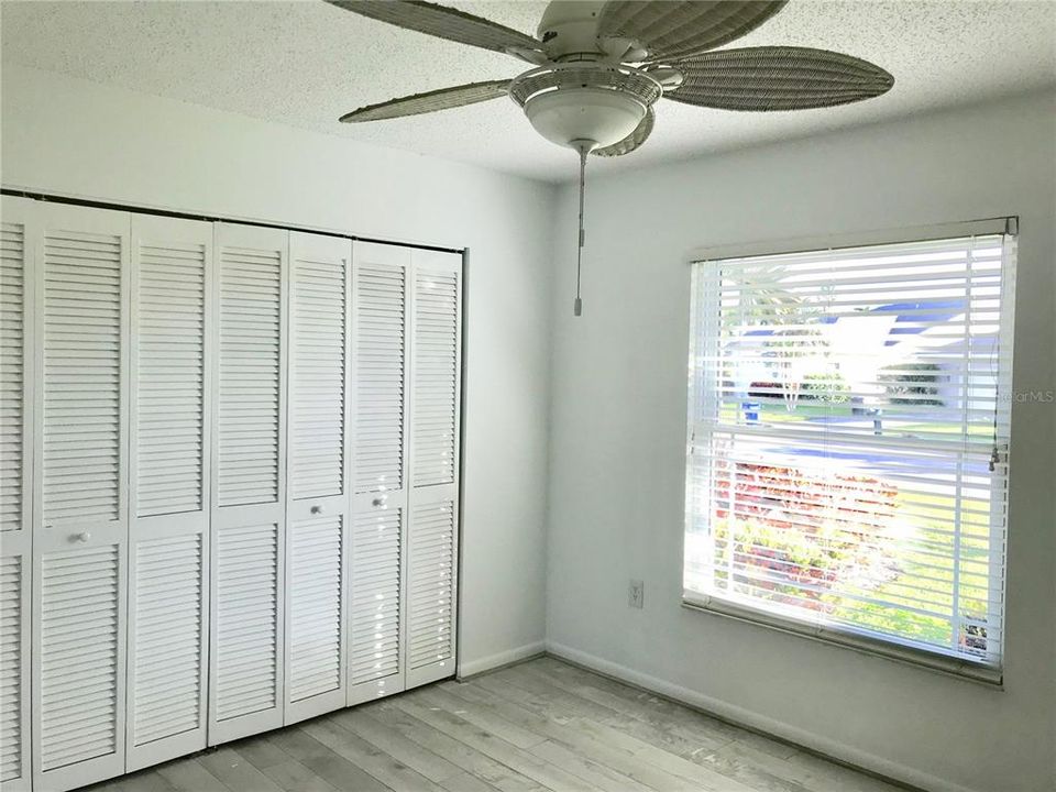 Second bedroom with a view of beautiful landscaping