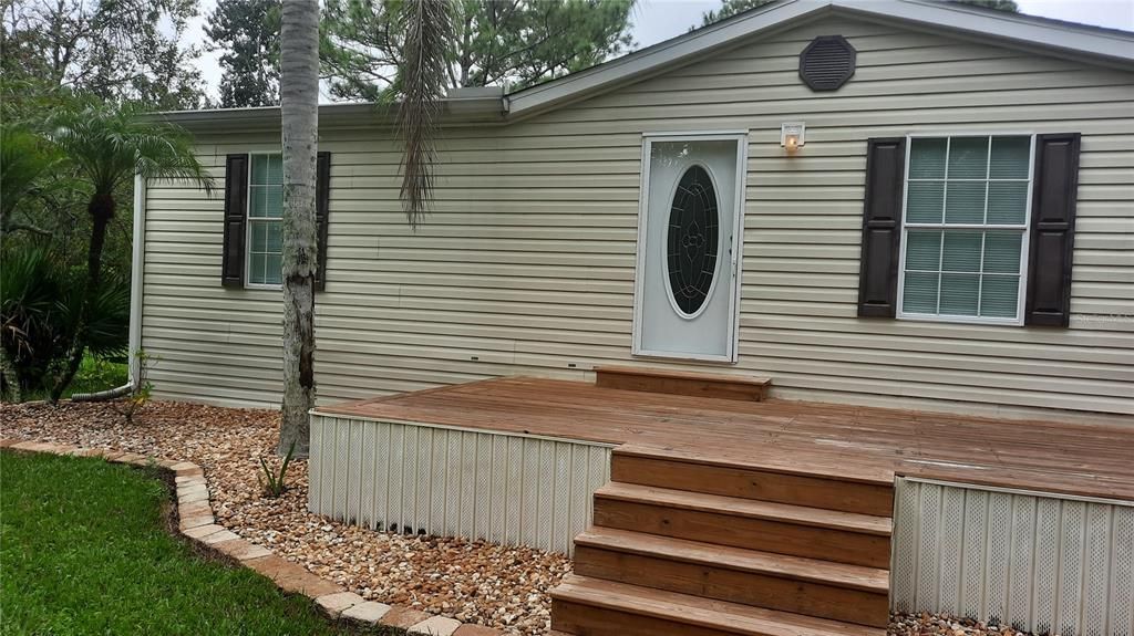 Front entry & large wooden deck