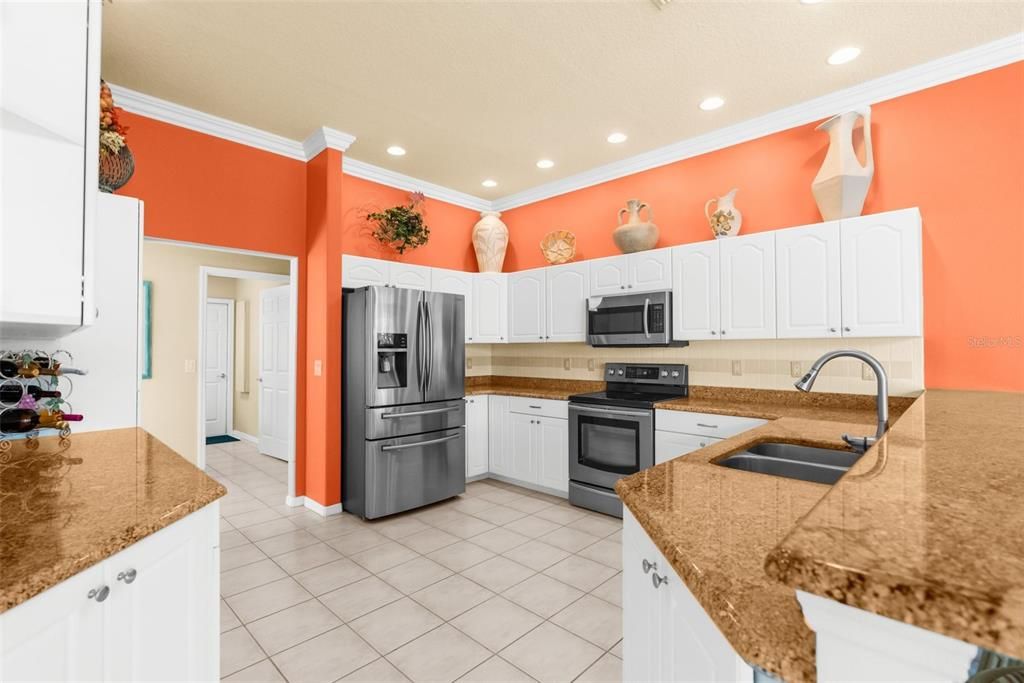 Spacious kitchen with granite countertops, breakfast bar, and newer stainless steel appliances