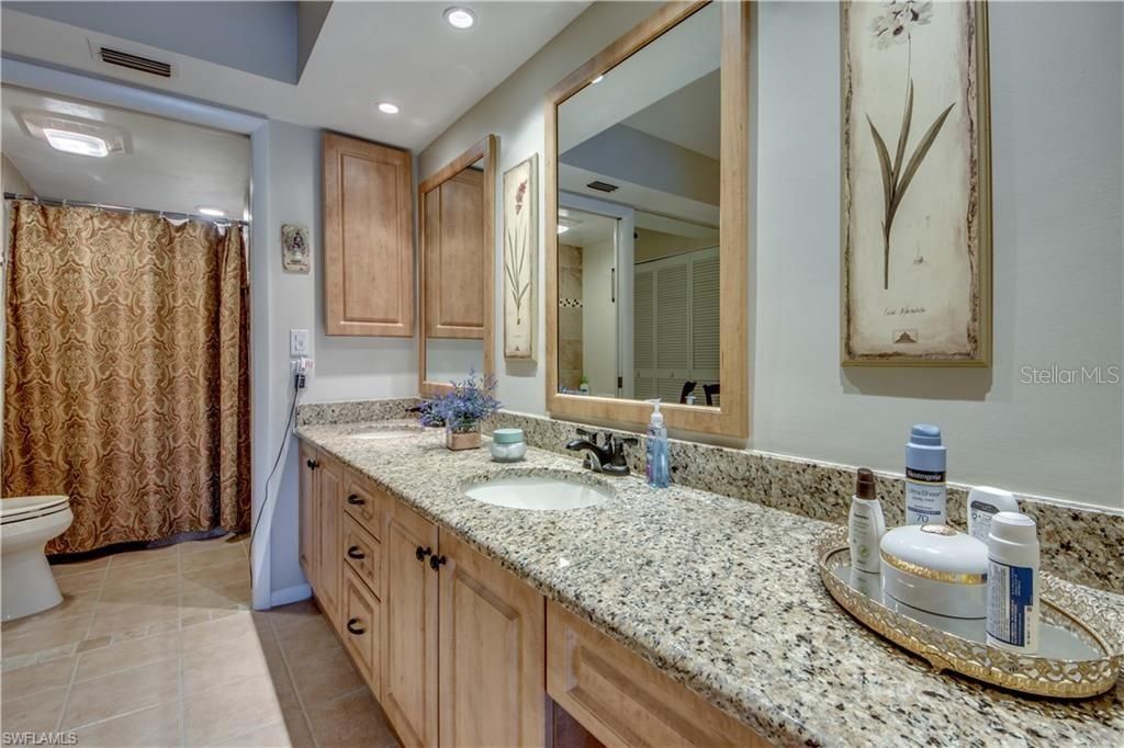 Spacious ensuite bathroom with double vanities, walk-in shower and his and hers closets to the left.