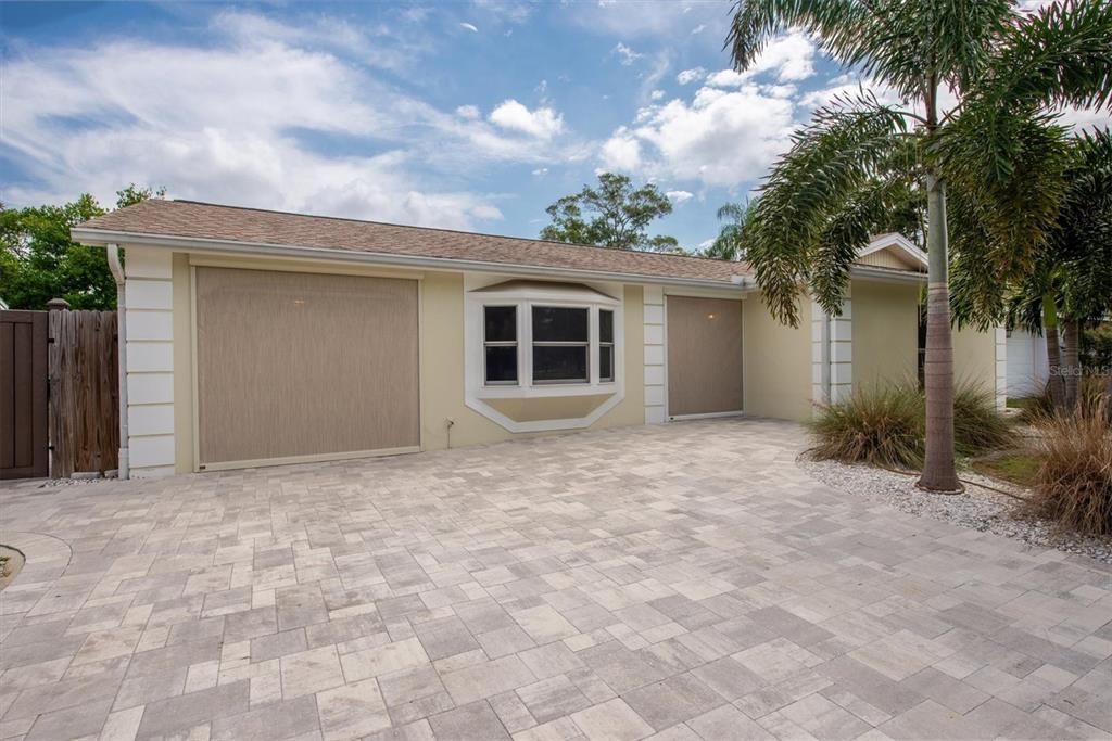 Front of House with garage and front door screens