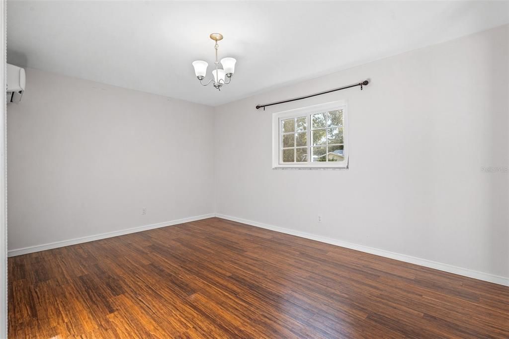 Large master bedroom with beautiful wood floors and separate temperature control