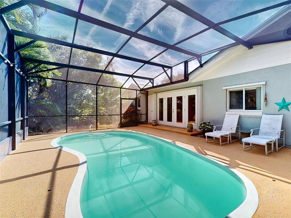 French Doors from the sunroom open to the pool