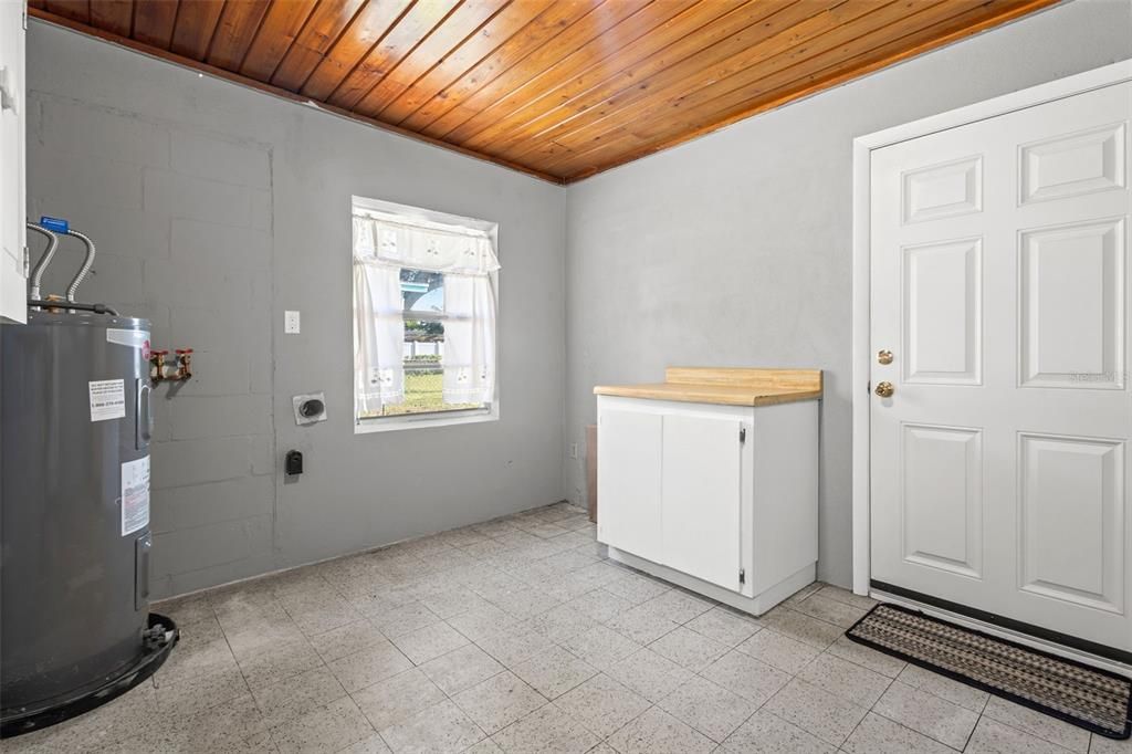 Laundry room with storage space.