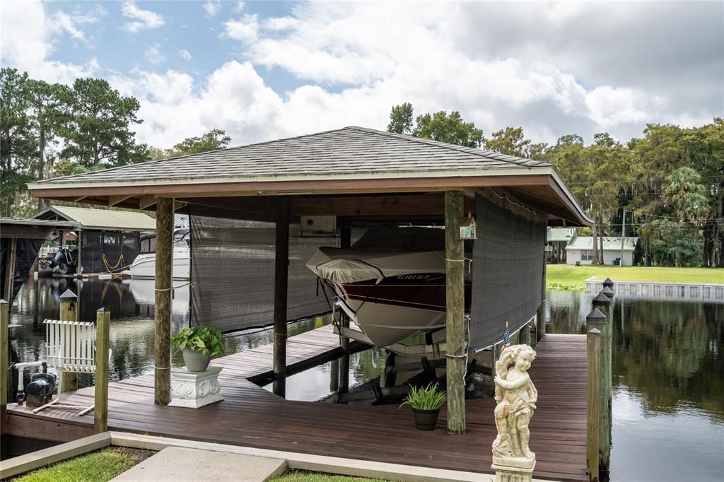 Large boathouse with 6,000 lb lift can store a 25' boat.