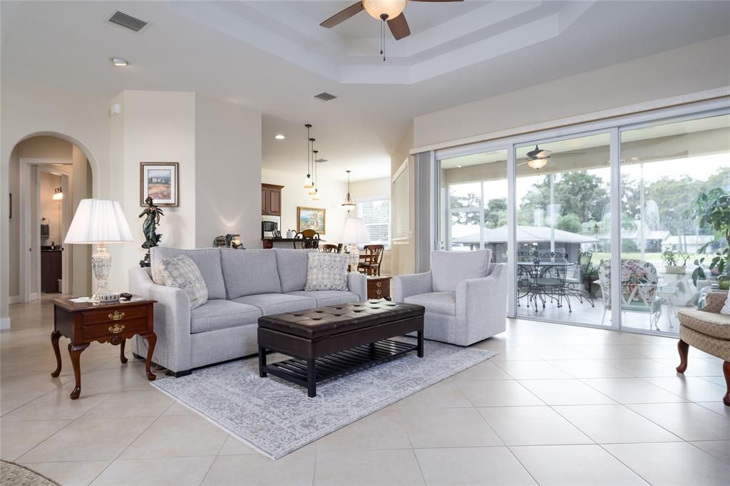 Main living area towards lanai and boathouse. Tall ceilings throughout.