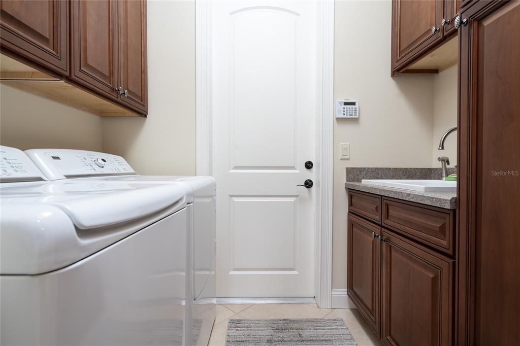 Laundry room towards the oversized garage. The cabinets match the kitchen.