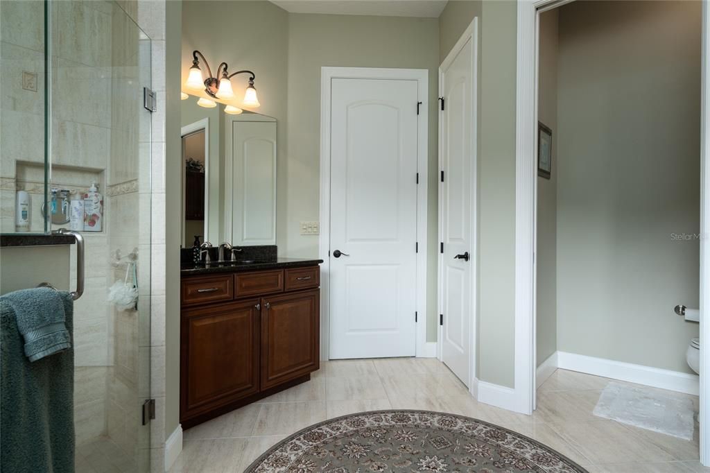 Ensuite bath towards entrance. Water closet at right. All toilets are comfort height.