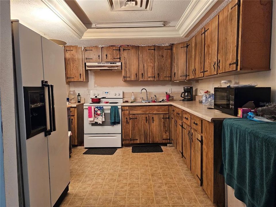 kitchen has plenty of cabinetry to fit all of your kitchen goods.