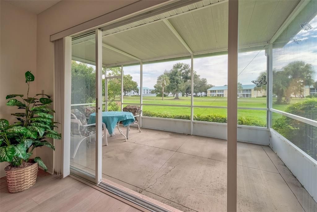 Looking into the lanai from the villa and out to the golf course.