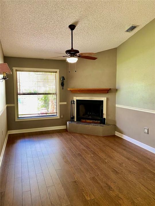 Perfect Den/Office/Study.... Vaulted Ceiling... Wood-Burning Fireplace for the Chilly Days....   Beautiful Engineered Hardwood Flooring, Easy Care