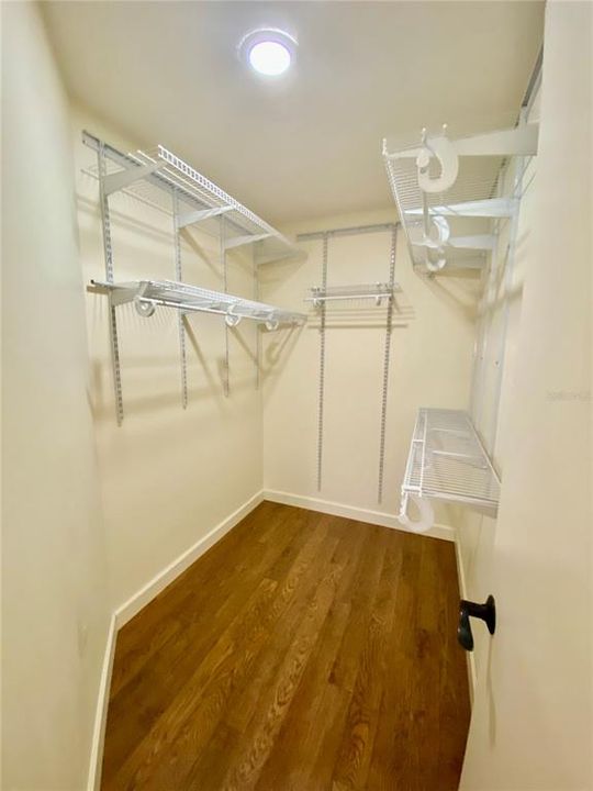 Primary Walk-In Closet with Good Shelving on Both Sides