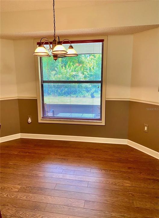 Open Dining Room with View of the Backyard, Chair Rail, Engineered Hardwood Floor