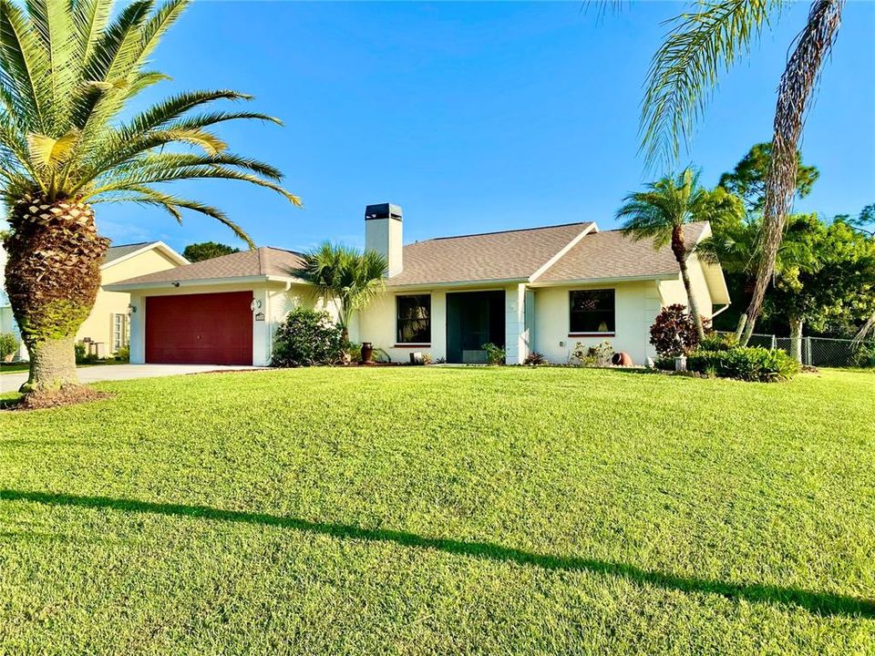 Tropical Landscape Frame this Unique Home.......  Notice the Newer Roof.....  Yes, That is a Real Chimney in FL ;))