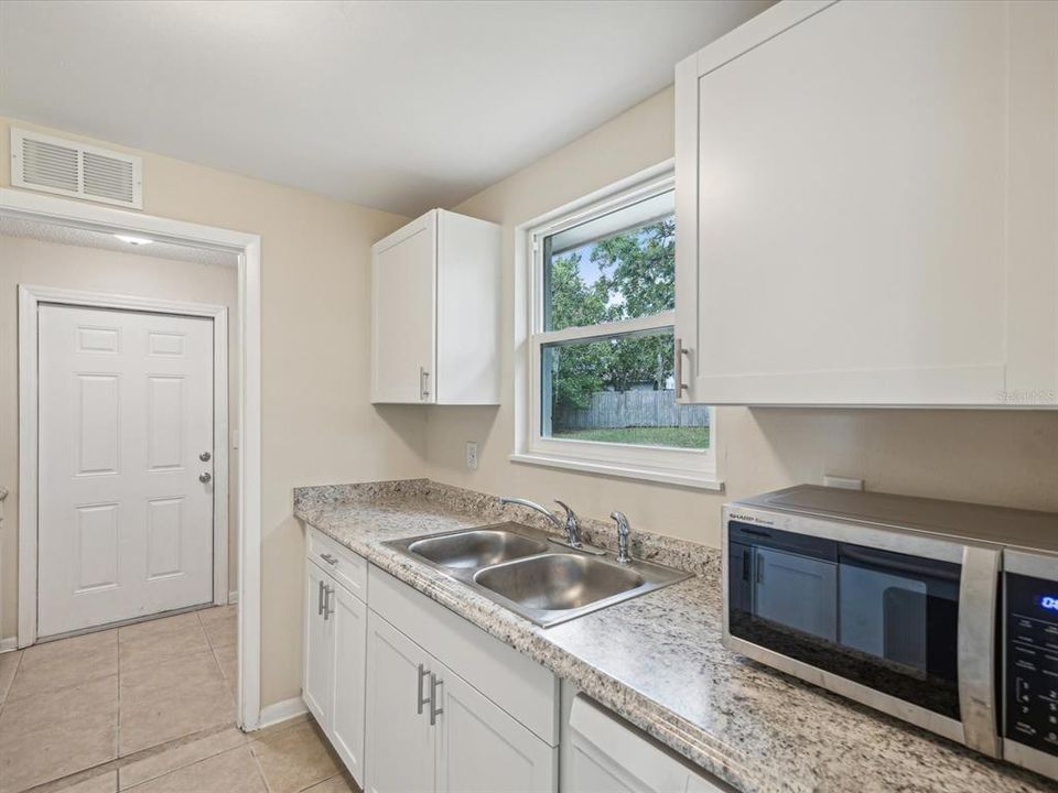 Kitchen overlooks Back Yard