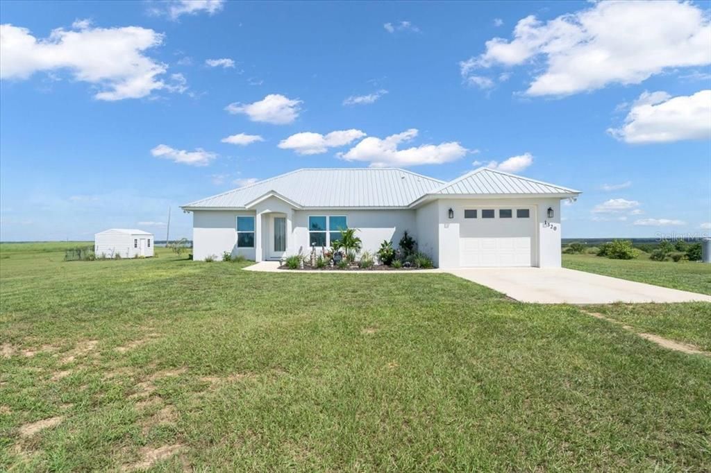 Front of House with 12x16 shed with roll up door