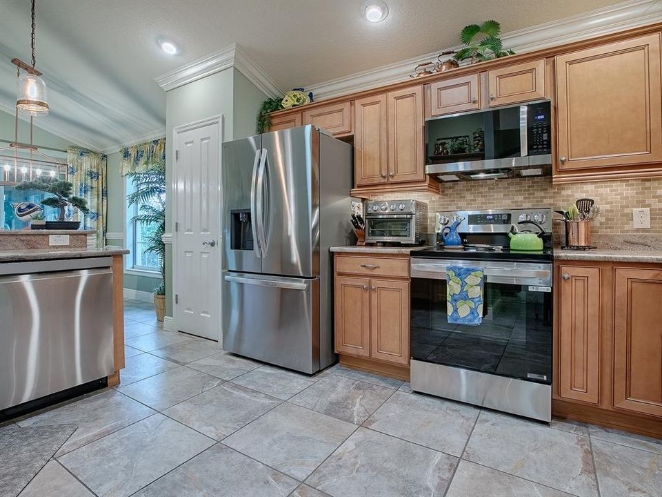 CHERRY CABINETRY, GRANITE COUNTER TOPS AND TILE BACKSPLASH.