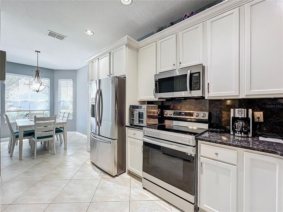 Spacious kitchen with large dinette area.