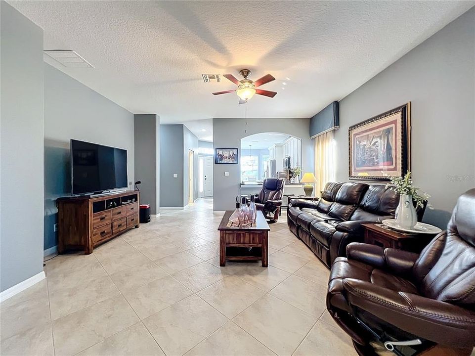 Large family room, high ceilings and view of kitchen and den area.