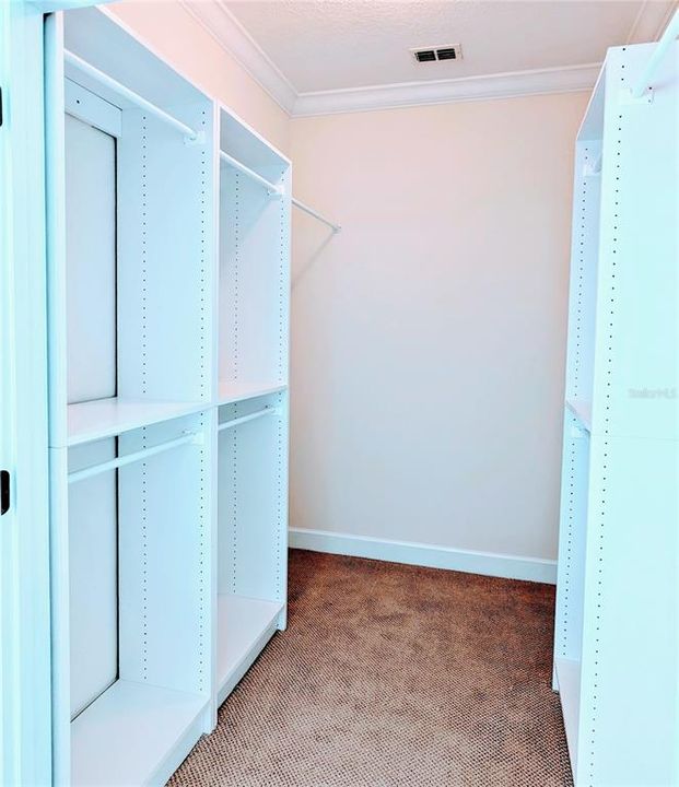 Loft walk-in closet with built-in shelves