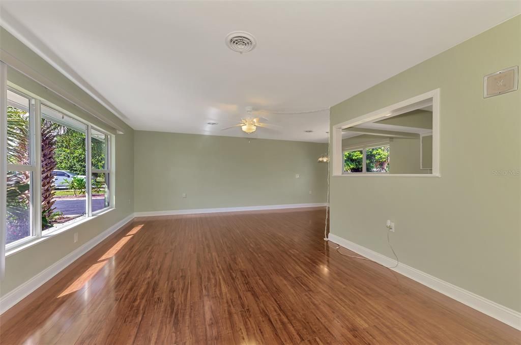 Beautiful Piano Laminate flooring.  It shines like a baby grand piano.  NOte the large front window.