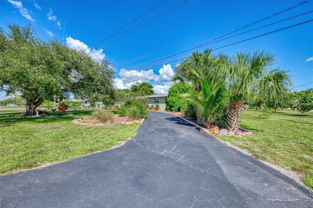 Wide circular drive way gives many parking spaces.  As you drive around the circular drive, you pass the front door of the main home and the front door of the mother in laws apartment.