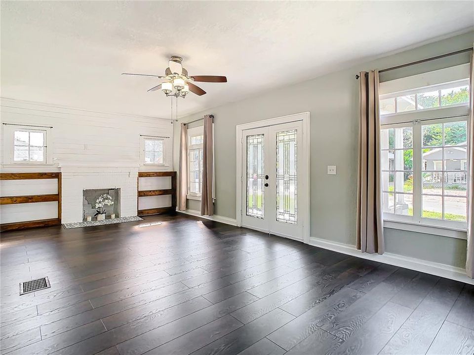 Large living room with fireplace and lots of natural light