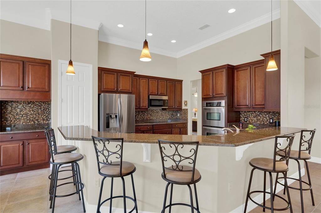 breakfast bar with seating and pendant light