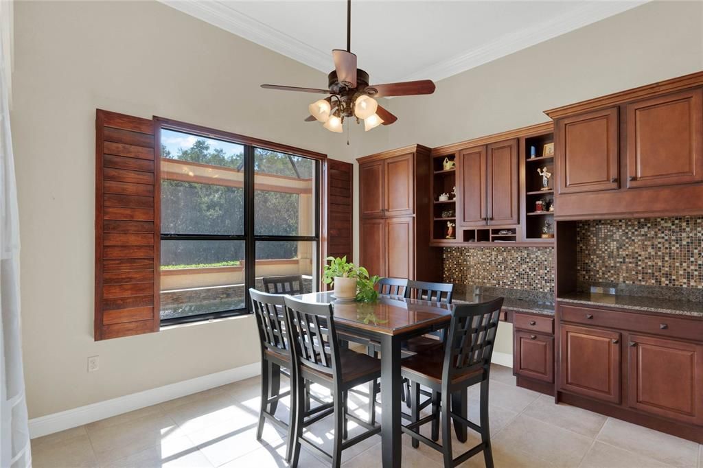 cozy dinette area with additional built-in cabinetry and a desk