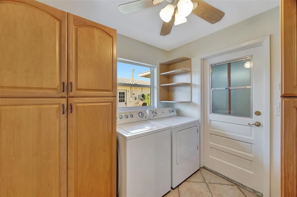 The laundry area has storage and leads into the garage