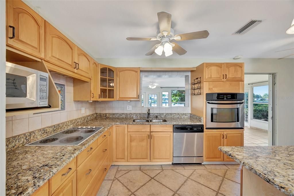 The kitchen has granite counters and stainless steel appliances and plemty of storage