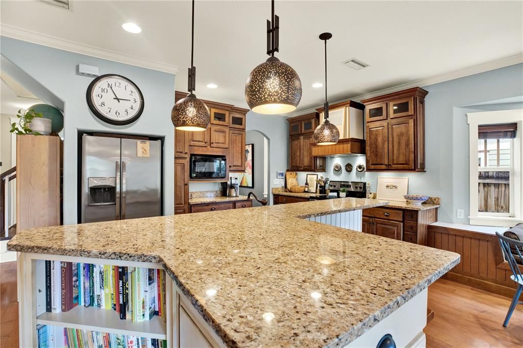 The kitchen offers plenty of counter space along with bookshelves to house your most loved cookbooks