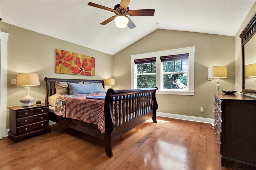 The upstairs primary bedroom features cathedral ceilings and plenty of space for the grandest furniture.