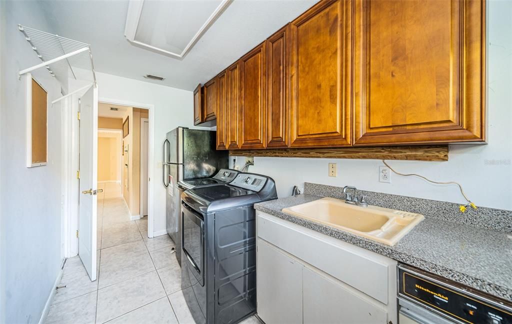 Laundry room with view toward kitchen area