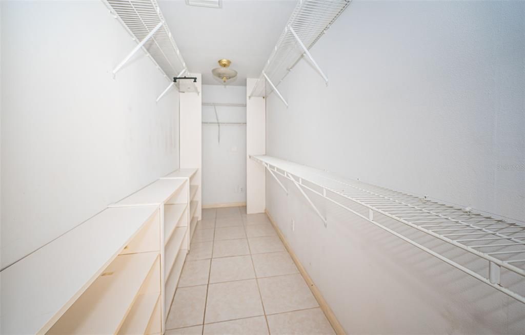 Primary walk in closet with lots of room for storage, shoes and clothes