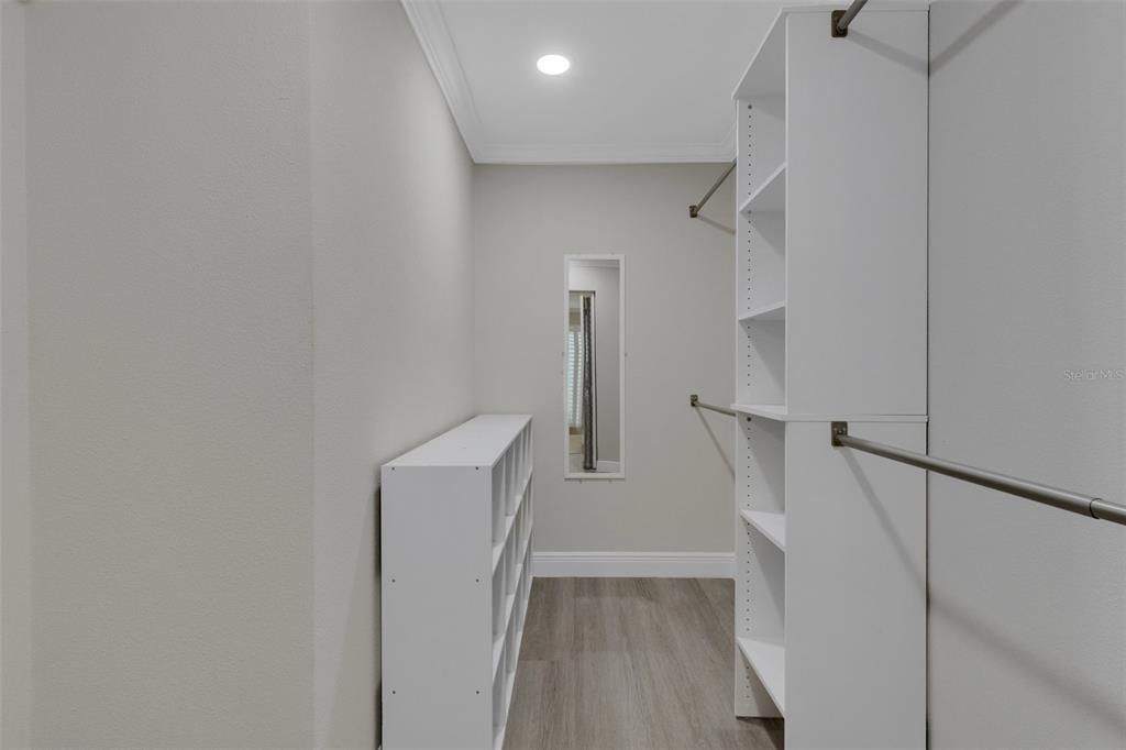 Large master closet with custom cabinetry~