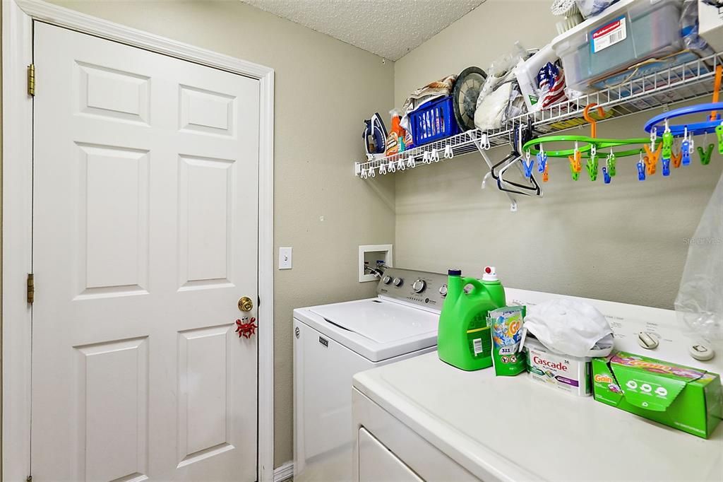 Inside laundry room located between garage and Kitchen