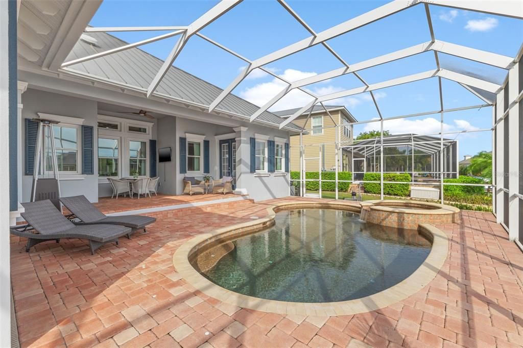 Beautiful heated pebble tech pool, spa with gorgeous pavers and view to waterfront