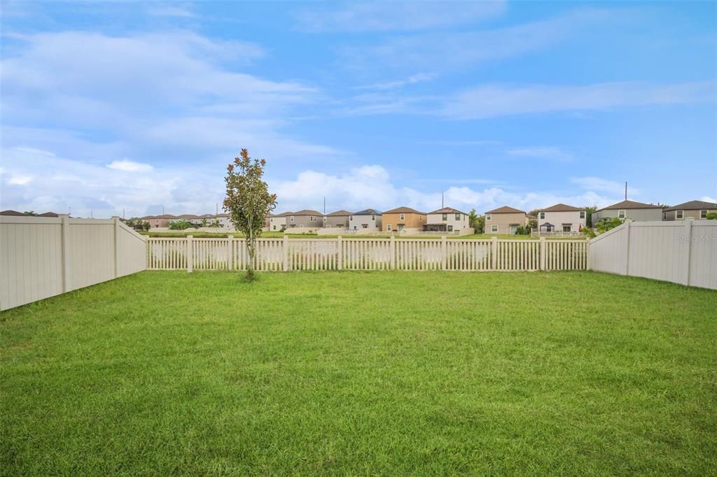 Spacious fully fenced backyard with the pond beyond!