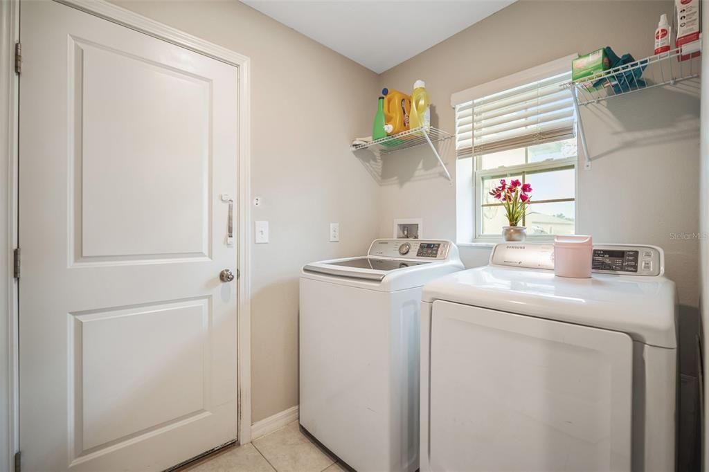 Laundry Room is next to the front door and the garage is on the other side.