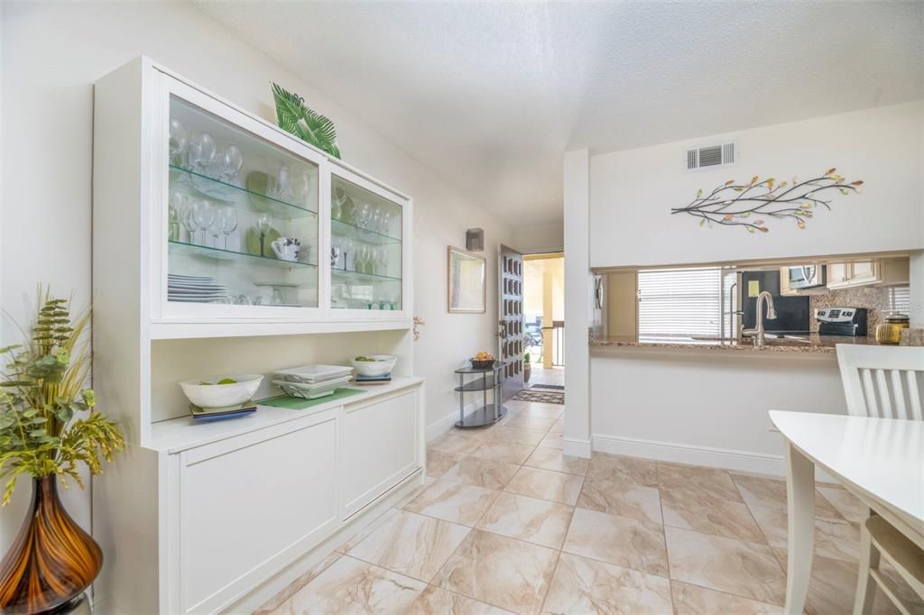 Dining room with ceramic tile flooring flows seamlessly through the home.