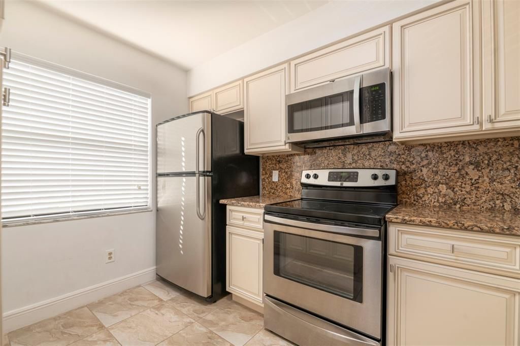 Kitchen is light and bright with big window.